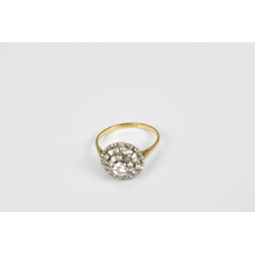 150 - An 18ct gold and diamond cluster ring, with central round cut 0.20 carat diamond, shank stamped 18 c... 