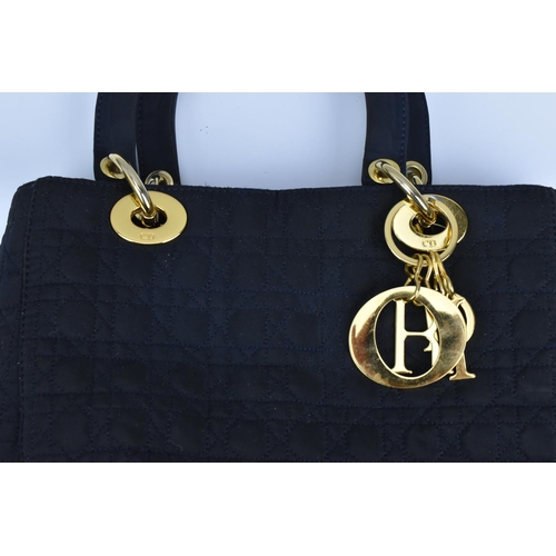 173 - A circa 1990's Christian Dior Lady Dior MM bag in Cannage quilted navy fabric with gold tone hardwar... 