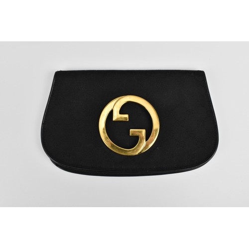 174 - A 1970's Gucci black monogrammed canvas Blondie clutch bag with large gold tone double G interlocked... 