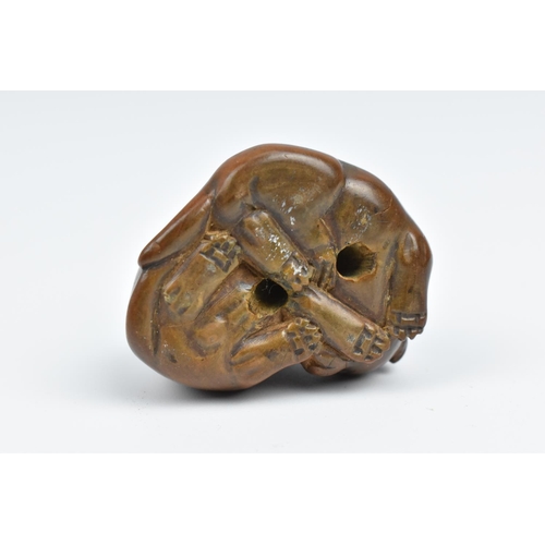 25 - A Japanese carved wood netsuke, 19th century, modelled as two puppies, unsigned, 3 cm high x 3.5 cm ... 