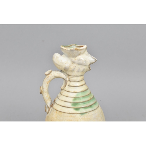 42 - A Chinese Qingbai glazed pottery ewer of ovoid shape  with phoenix head and turned detail to the nec... 