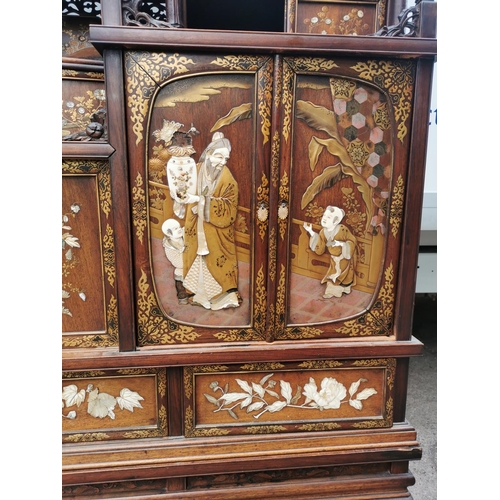 47 - A Japanese Meiji period Shibayama inlaid and lacquer display cabinet, with finely carved ivory, moth... 