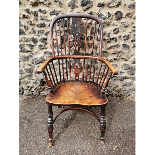 156 - A 19th century ash windsor chair with comb back, pierced splat, supported on turned legs with crinol... 