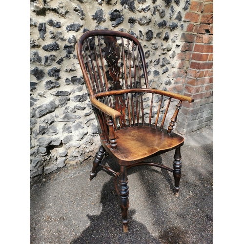 156 - A 19th century ash windsor chair with comb back, pierced splat, supported on turned legs with crinol... 