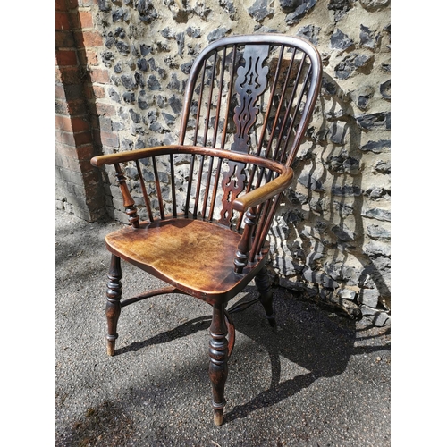 156 - A 19th century ash windsor chair with comb back, pierced splat, supported on turned legs with crinol... 