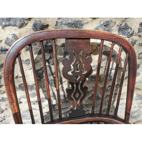 156 - A 19th century ash windsor chair with comb back, pierced splat, supported on turned legs with crinol... 