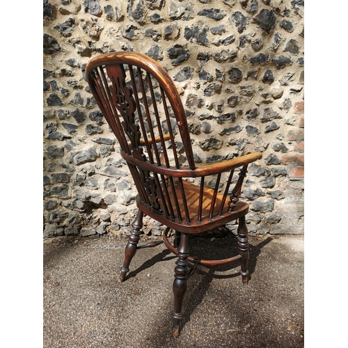 156 - A 19th century ash windsor chair with comb back, pierced splat, supported on turned legs with crinol... 