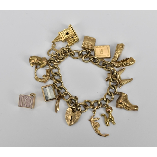 190 - A 9ct gold charm bracelet, the cable chain holding various miniature charms of buildings, animals, s... 