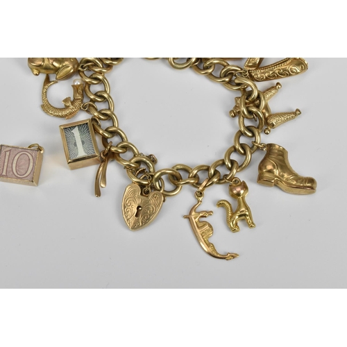 190 - A 9ct gold charm bracelet, the cable chain holding various miniature charms of buildings, animals, s... 