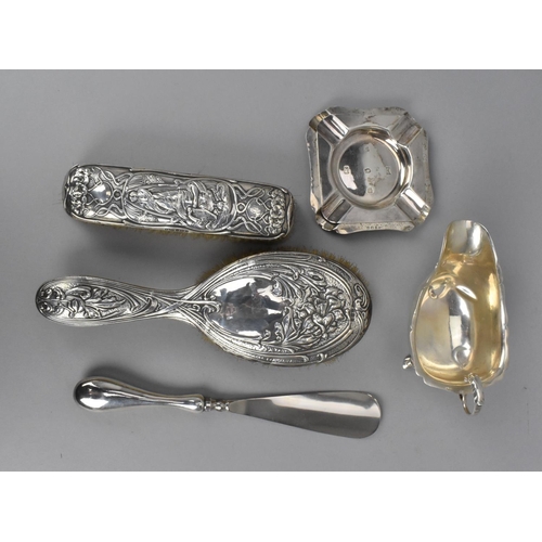 191 - A small miscellaneous group of silver, comprising two Art Nouveau silver mounted brushes, by differe... 