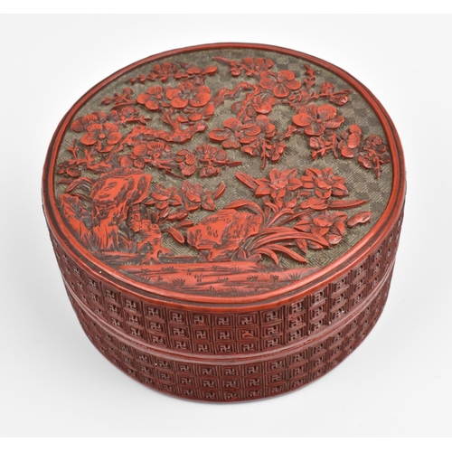 2 - A Chinese Qing dynasty carved cinnabar lacquer box, of cylindrical form, the lid with intricately de... 