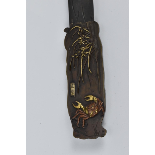 49 - A Japanese Meiji period bronze page turner, the carved handle with relief monkeys in a fruit tree to... 