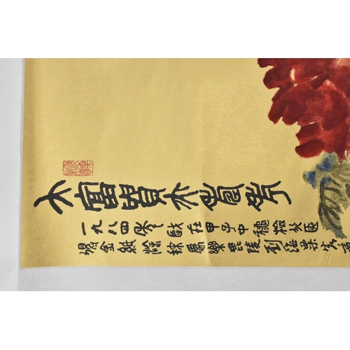 58 - A large Chinese scroll painting on paper, laid on silk, depicting blooming red flowers and foliage o... 