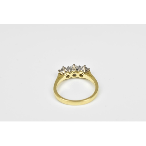 198 - An 18ct yellow gold and three stone diamond ring, the central diamond around 0.26 carat, the shank m... 