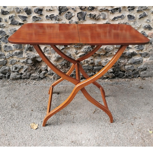 193 - A 19th century mahogany folding campaign or coaching table, raised on scissor action shaped x-frame ... 