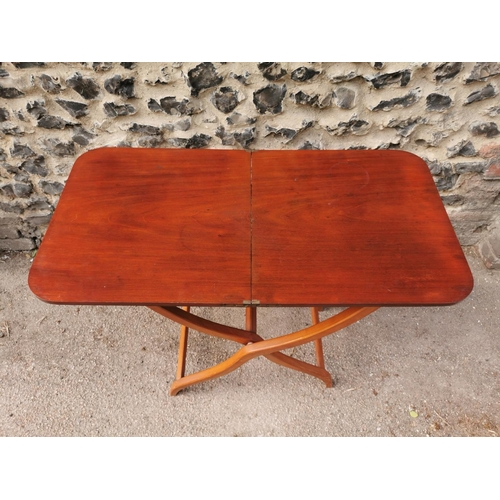 193 - A 19th century mahogany folding campaign or coaching table, raised on scissor action shaped x-frame ... 