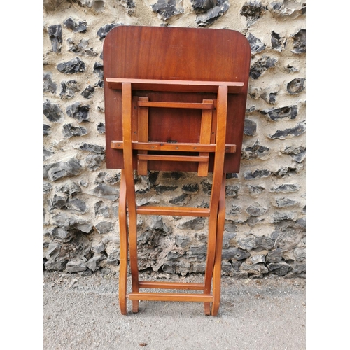 193 - A 19th century mahogany folding campaign or coaching table, raised on scissor action shaped x-frame ... 