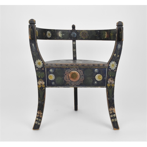 196 - A Norwegian folk art painted and stained wooden chair with horse shoe back, on three legs, designed ... 