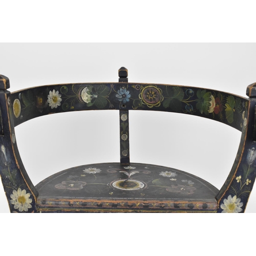 196 - A Norwegian folk art painted and stained wooden chair with horse shoe back, on three legs, designed ... 