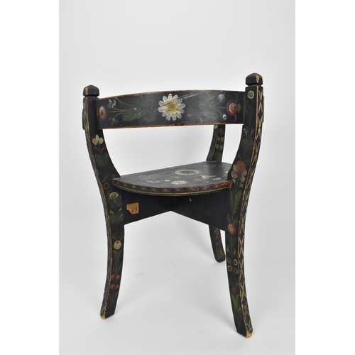 196 - A Norwegian folk art painted and stained wooden chair with horse shoe back, on three legs, designed ... 