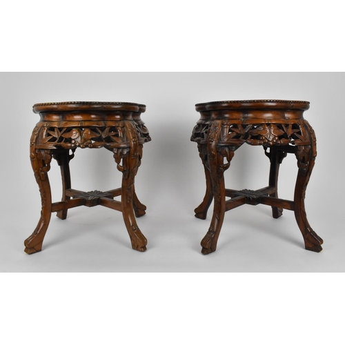 75 - A pair of Chinese carved hardwood and marble jardiniere stands, with beaded rim and pierced foliate ... 