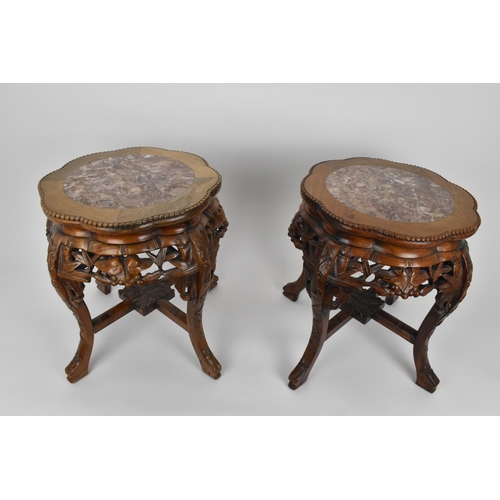 75 - A pair of Chinese carved hardwood and marble jardiniere stands, with beaded rim and pierced foliate ... 