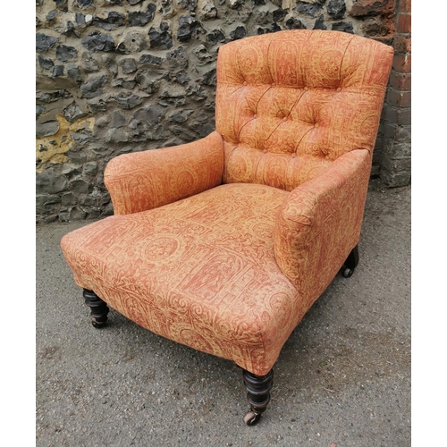 194 - A Victorian walnut and upholstered Howard style armchair, the buttoned back seat upholstered with Cl... 