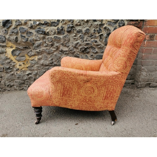 194 - A Victorian walnut and upholstered Howard style armchair, the buttoned back seat upholstered with Cl... 