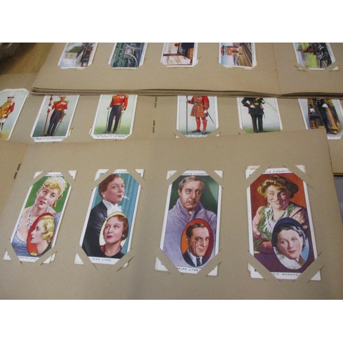 A collection of cigarette card album to include 1939 Gallagher Army Badge  cards, 1939 Players Unifor