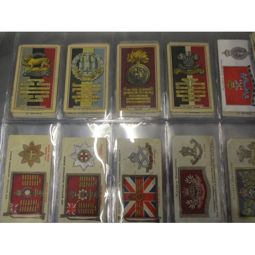 A collection of cigarette card album to include 1939 Gallagher Army Badge  cards, 1939 Players Unifor