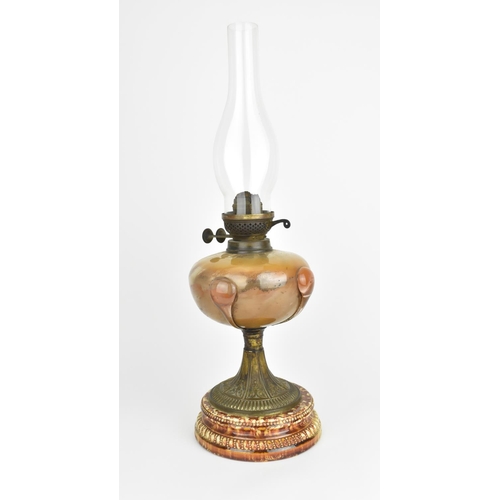 42 - A 19th century Arts and Crafts style oil lamp, with bulbous glass body on a spreading metal pedestal... 