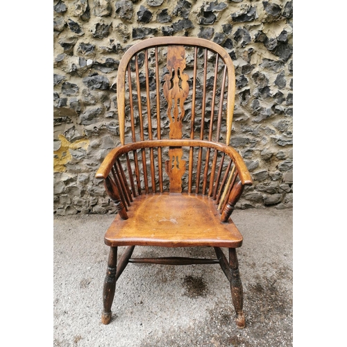 185 - A 19th century ash and elm windsor armchair, with hooped back with central pierced back, flanked wit... 