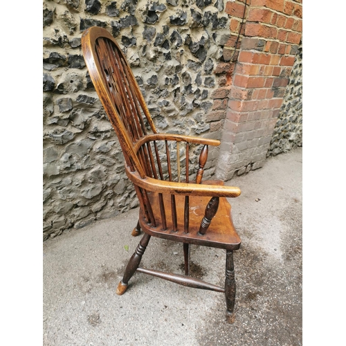 185 - A 19th century ash and elm windsor armchair, with hooped back with central pierced back, flanked wit... 