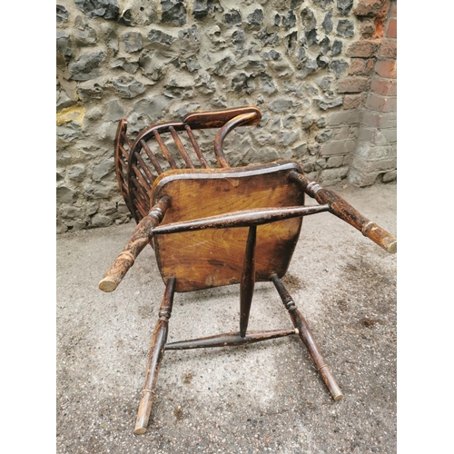 186 - A 19th century ash and elm windsor armchair, with  turned spindle back and broad arm rail, supported... 