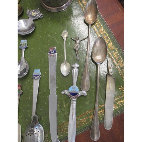 29 - Vintage caddy spoons, some with enamelled tourist emblems together with white metal items and a silv... 