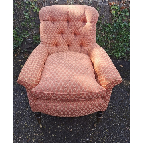 190 - A Victorian upholstered Howard style armchair, with button back, deep seat, supported on turned legs... 