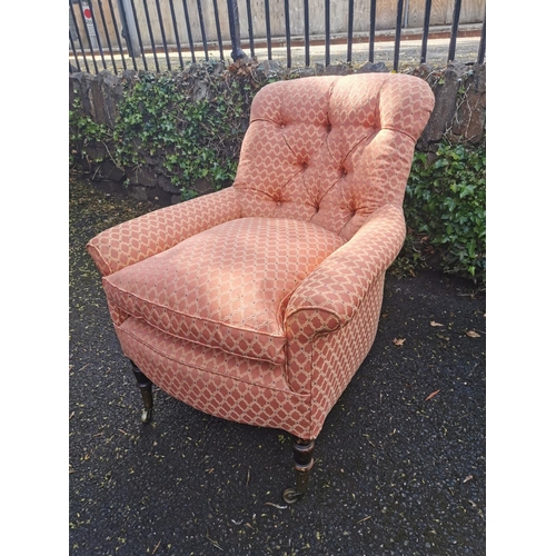 190 - A Victorian upholstered Howard style armchair, with button back, deep seat, supported on turned legs... 