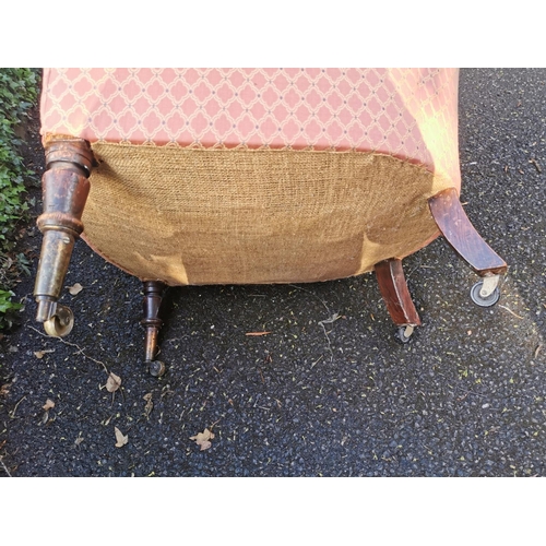 190 - A Victorian upholstered Howard style armchair, with button back, deep seat, supported on turned legs... 