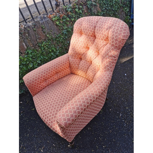 190 - A Victorian upholstered Howard style armchair, with button back, deep seat, supported on turned legs... 