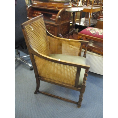 65 - An early 20th century caned oak armchair
Location: C-L