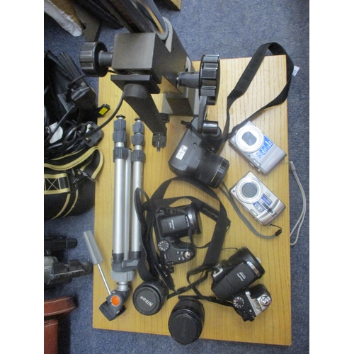 70 - Cameras and photographic equipment to include a Fuji FinePix S3300, three tripods, a Fuji Fine Pix S... 