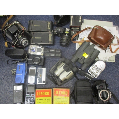 72 - Cameras and photographic equipment to include vintage Kodaks, a Nikon EM modern digital cameras, acc... 