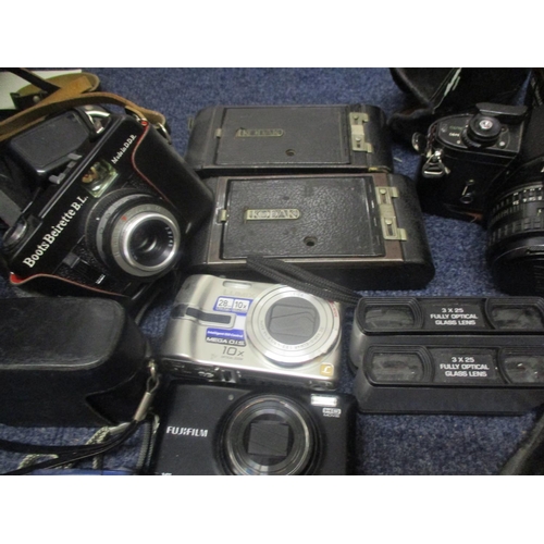 72 - Cameras and photographic equipment to include vintage Kodaks, a Nikon EM modern digital cameras, acc... 