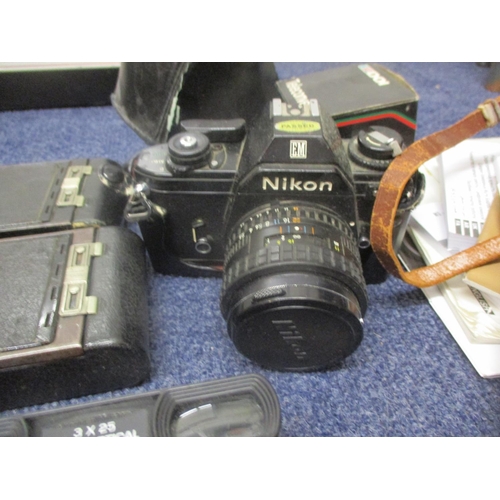 72 - Cameras and photographic equipment to include vintage Kodaks, a Nikon EM modern digital cameras, acc... 