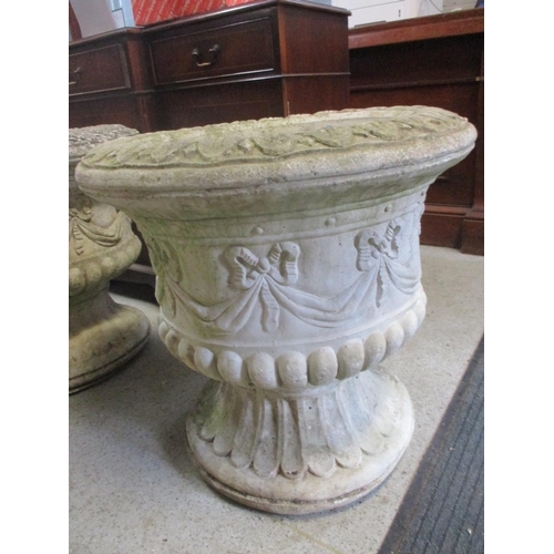 87 - A pair of large composition stone garden urns with ribbon and swag ornament 61cm h x 62cm d
Location... 