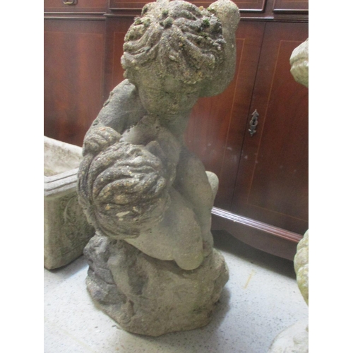 92 - A composition stone garden cherub figurine carrying wheat sheaves, another composition stone garden ... 