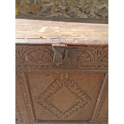 188 - A late 17th century oak coffer, with carved floral frieze above three carved lozenge panels, 64 cm h... 