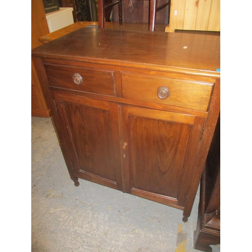 77 - A 1920's mahogany cupboard, two short drawers above fielded panels on turned legs, and a two tier ta... 