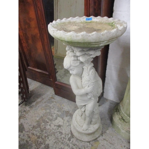 82 - A composition stone birdbath support by a boy Location: G