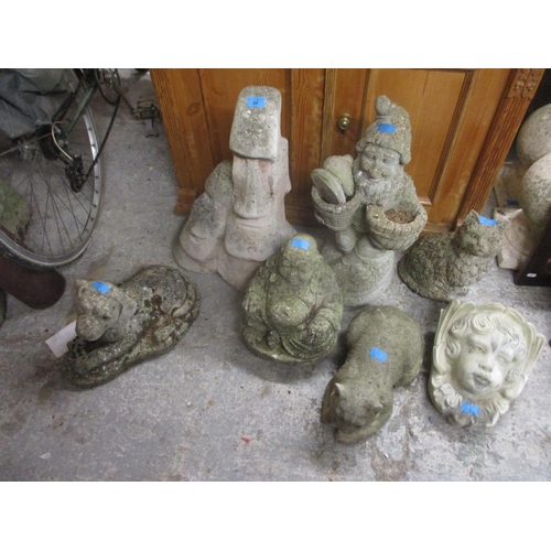 84 - Composition stone garden figures Easter Island figure, a model of a dog, gnomes, a model cat, a face... 